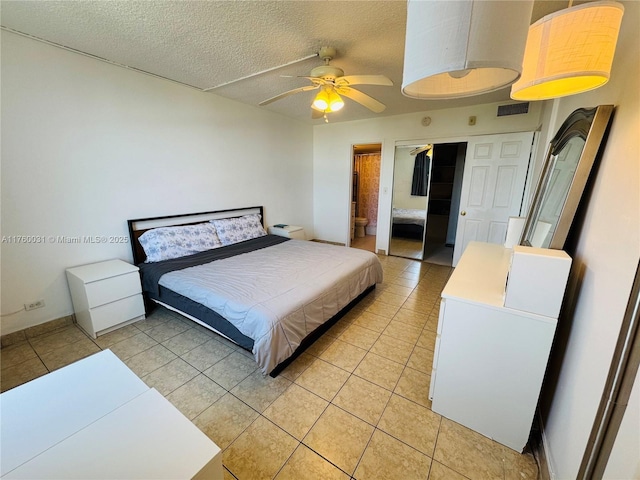 3660 NE 166th St Unit 812, North Miami Beach, FL 33160 - bedroom featuring light tile patterned floors, a textured ceiling, ceiling fan, baseboards, and ensuite bath