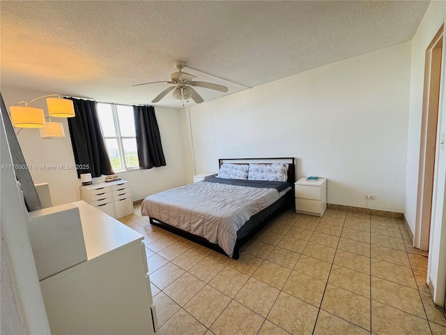 3660 NE 166th St Unit 812, North Miami Beach, FL 33160 - bedroom with a textured ceiling, light tile patterned flooring, ceiling fan, and baseboards