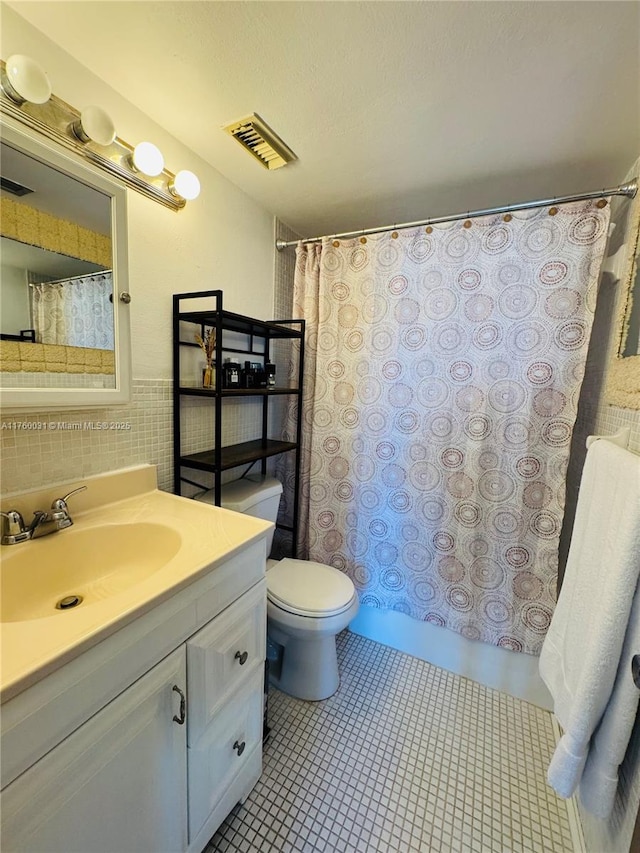 3660 NE 166th St Unit 812, North Miami Beach, FL 33160 - full bath featuring vanity, toilet, tile walls, a shower with curtain, and tile patterned flooring