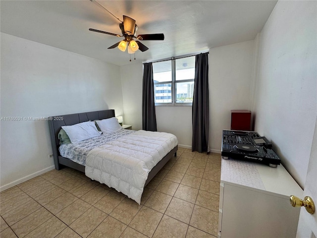 3660 NE 166th St Unit 812, North Miami Beach, FL 33160 - bedroom with light tile patterned floors, ceiling fan, and baseboards