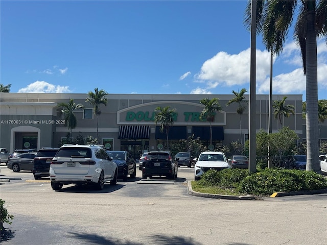 view of building exterior with uncovered parking