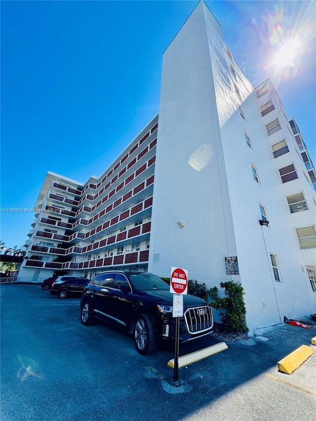 3660 NE 166th St Unit 812, North Miami Beach, FL 33160 - view of building exterior with uncovered parking