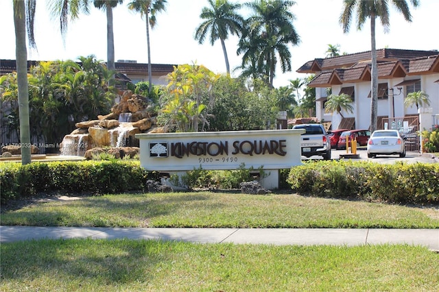 community / neighborhood sign with a lawn