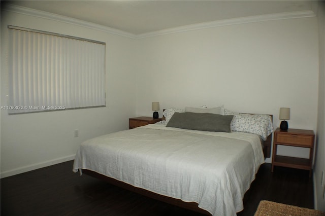 bedroom featuring ornamental molding, baseboards, and wood finished floors