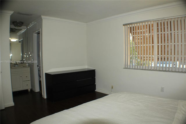 bedroom with a sink, dark wood-style floors, and ornamental molding