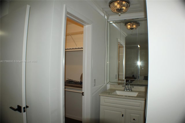 full bath featuring vanity and a walk in closet