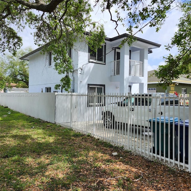 exterior space featuring a fenced front yard and stucco siding