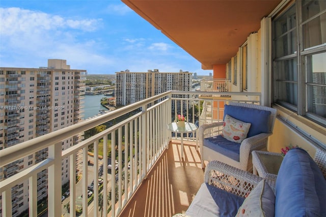 balcony featuring a city view and a water view