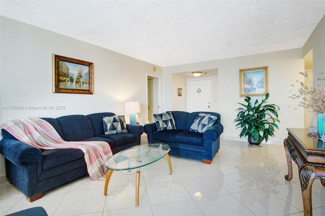 living room with light tile patterned flooring and a textured ceiling