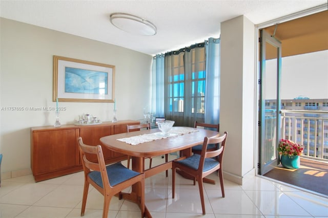 dining space featuring light tile patterned floors