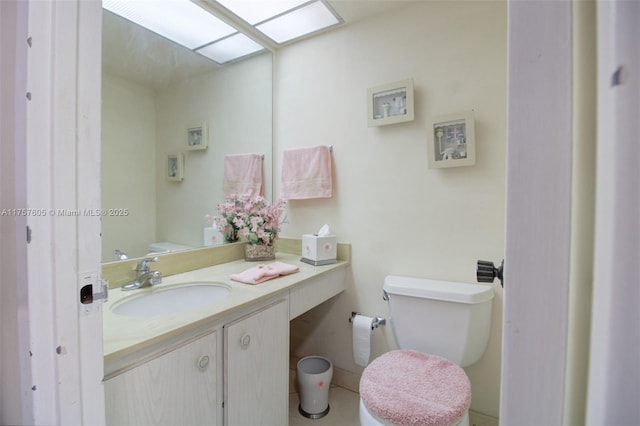 bathroom featuring toilet and vanity