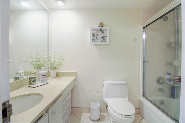 full bath featuring toilet, baseboards, shower / bath combination with glass door, tile patterned flooring, and vanity