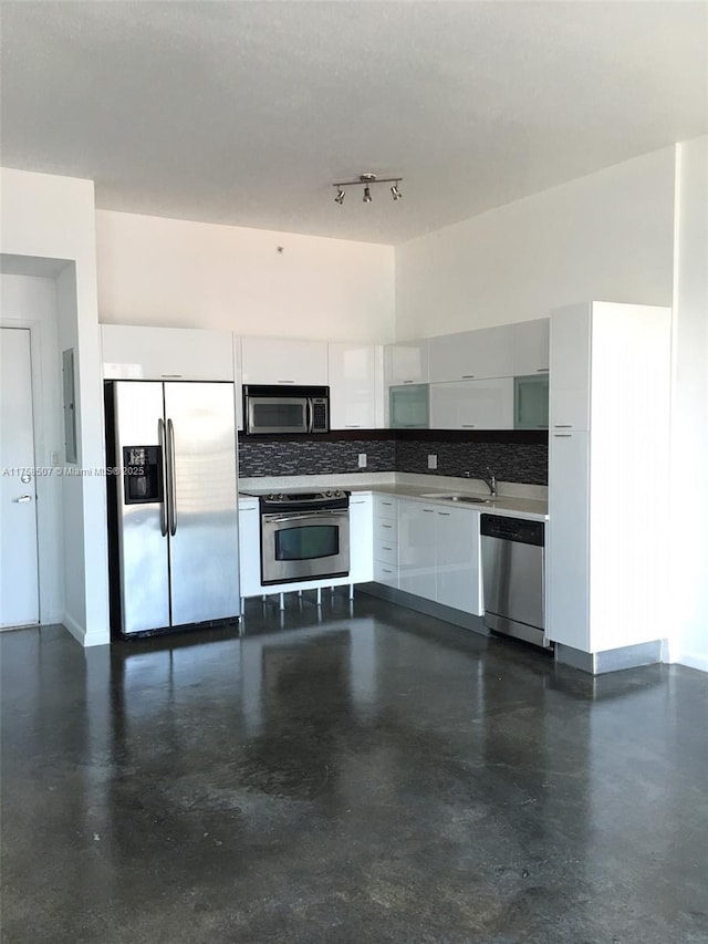 kitchen with stainless steel appliances, backsplash, modern cabinets, and white cabinets