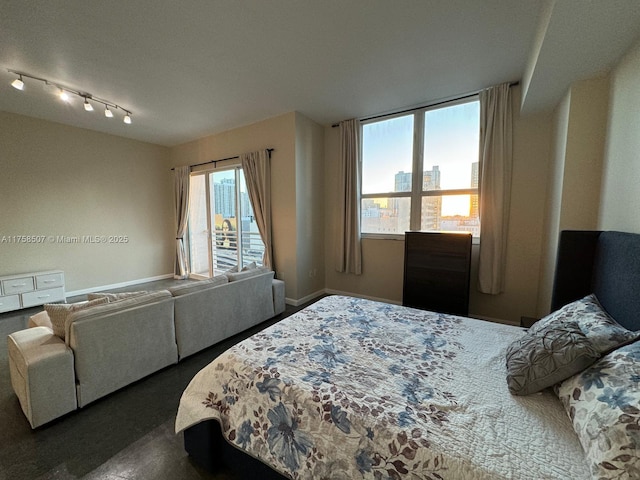 bedroom featuring multiple windows and baseboards