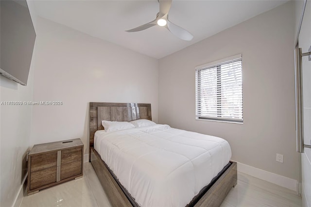 bedroom with ceiling fan and baseboards