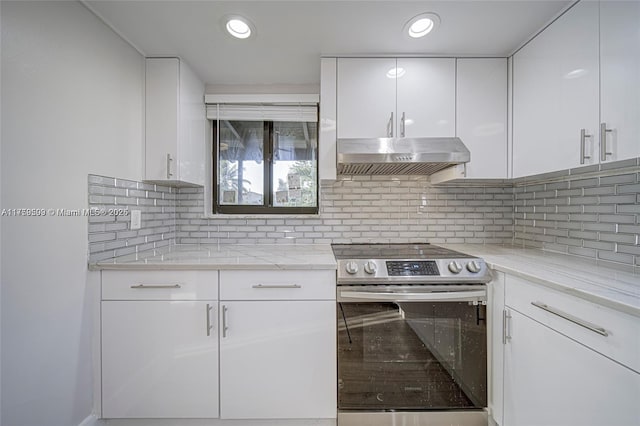 kitchen with tasteful backsplash, white cabinetry, recessed lighting, exhaust hood, and stainless steel electric range oven