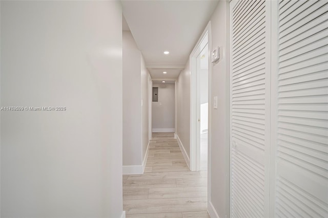 hall featuring recessed lighting, baseboards, and light wood finished floors