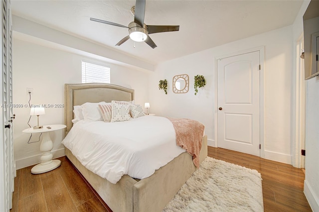 bedroom with ceiling fan, baseboards, and wood finished floors