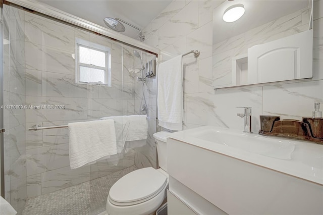 full bathroom featuring a marble finish shower, toilet, tile walls, and vanity