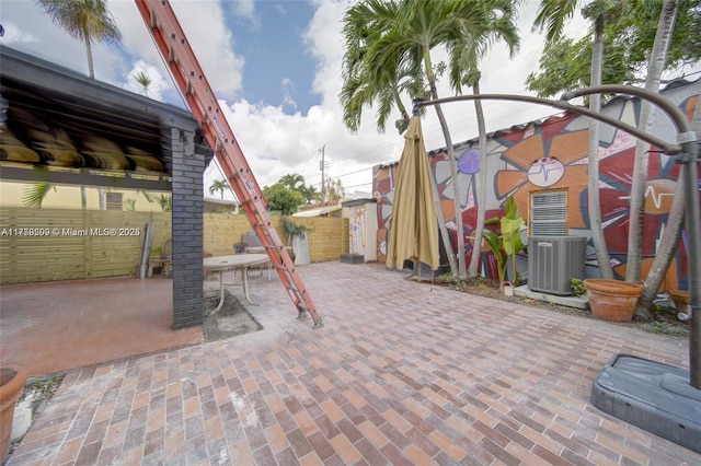 view of patio / terrace with central AC and fence