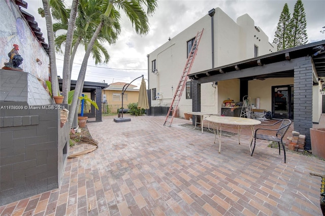 view of patio featuring outdoor dining area and fence