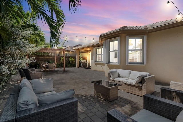 view of patio with an outdoor living space, outdoor dining area, and fence