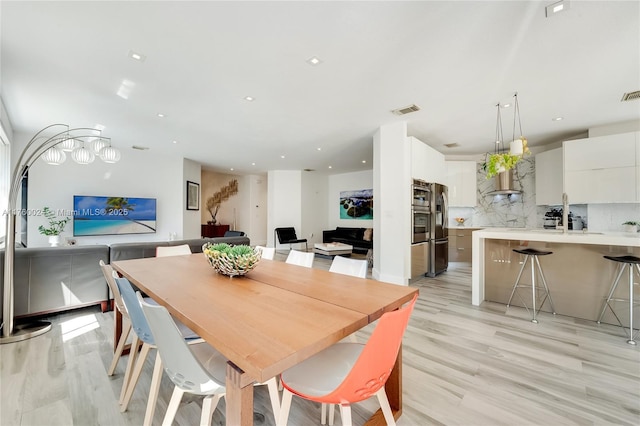 dining space featuring recessed lighting, visible vents, and light wood-style flooring