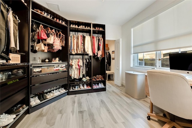 walk in closet with visible vents and wood finished floors