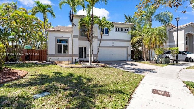 mediterranean / spanish-style house featuring a front yard, fence, stucco siding, concrete driveway, and a garage