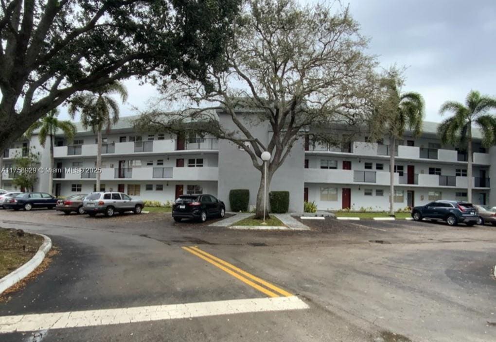 view of building exterior featuring uncovered parking