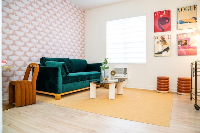 living area featuring baseboards and wood finished floors