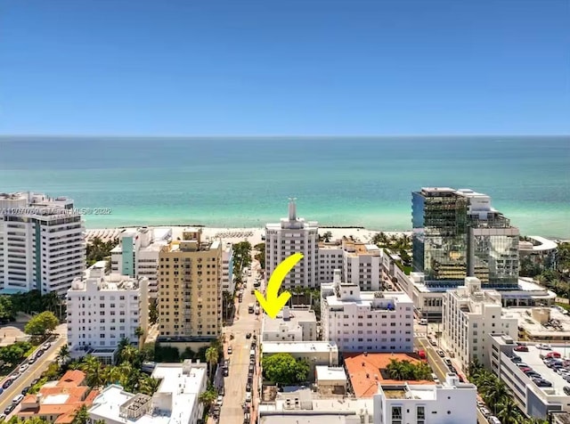 bird's eye view with a water view, a view of city, and a view of the beach