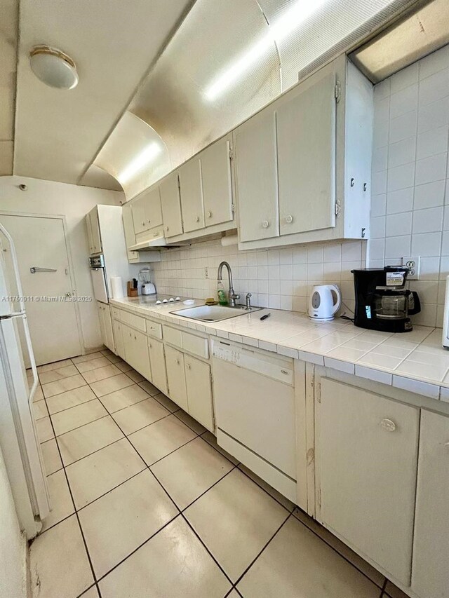 100 Lincoln Rd Unit 329, Miami Beach, FL 33139 - kitchen with white appliances, a sink, light tile patterned flooring, backsplash, and tile countertops