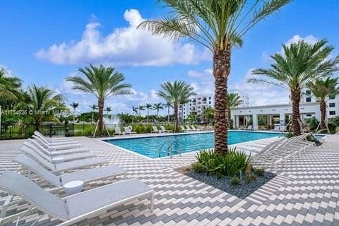 pool with a patio area and fence