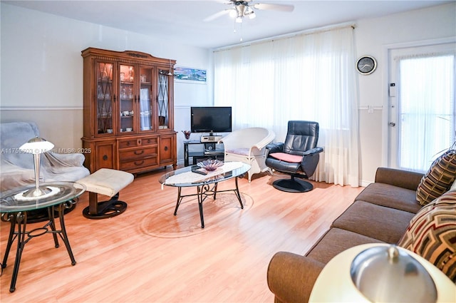 living area featuring wood finished floors and ceiling fan