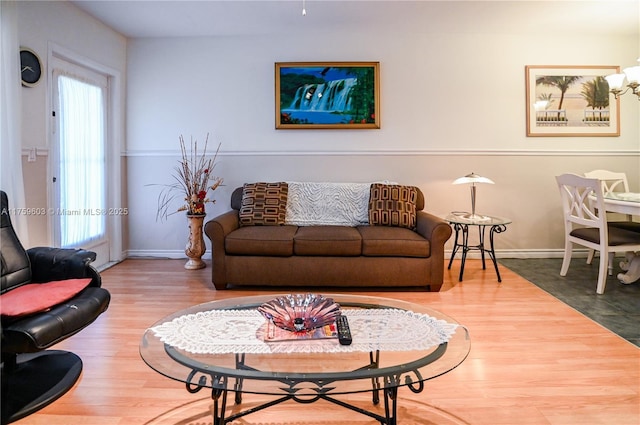 living area featuring baseboards and wood finished floors