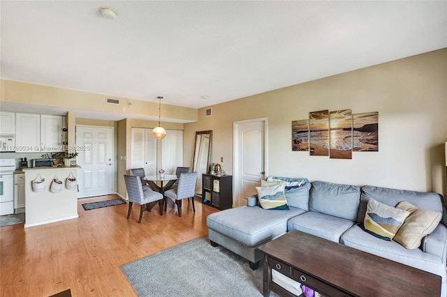 living room featuring visible vents and light wood finished floors