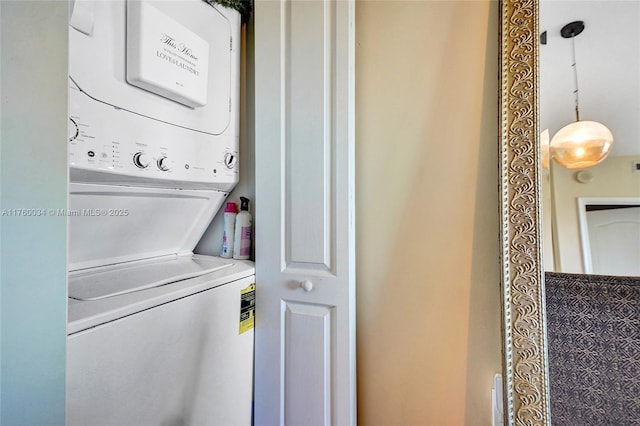 laundry room with laundry area and stacked washer / dryer