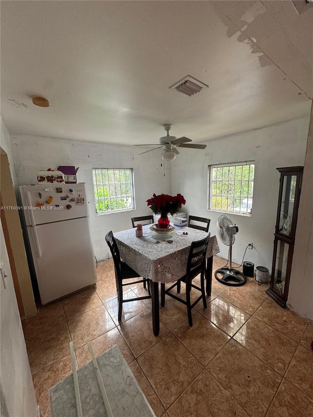 dining space with tile patterned floors and visible vents