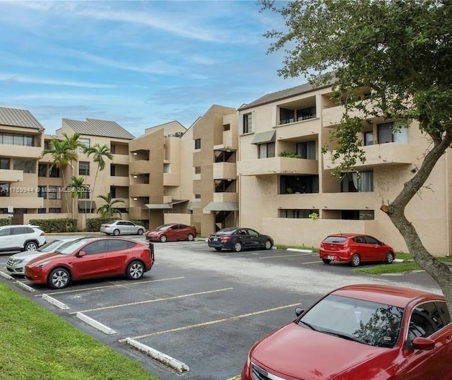 view of property with uncovered parking