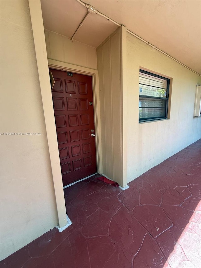 property entrance with stucco siding