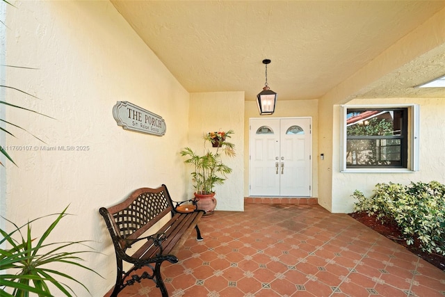 view of exterior entry with stucco siding