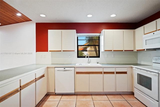 kitchen featuring a sink, recessed lighting, white appliances, light countertops, and light tile patterned floors