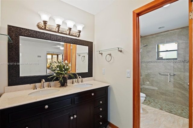 full bath with double vanity, a stall shower, toilet, and a sink