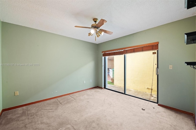 unfurnished room with ceiling fan, carpet, baseboards, and a textured ceiling