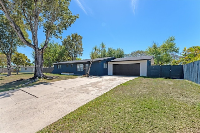 ranch-style home with a front yard, a gate, fence, driveway, and an attached garage