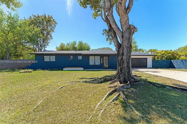 single story home with concrete driveway, an attached garage, fence, and a front lawn