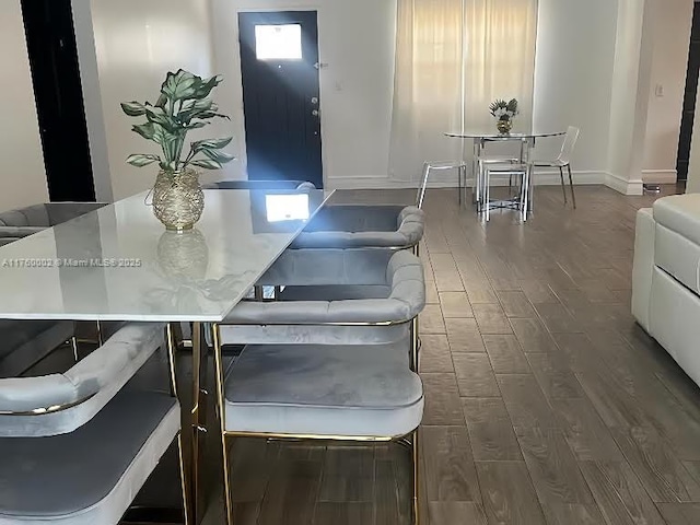 interior space with baseboards and dark wood-style flooring