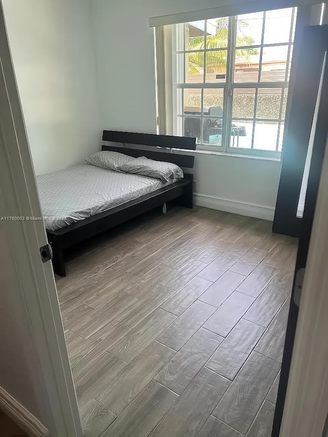 unfurnished bedroom featuring baseboards and wood finished floors