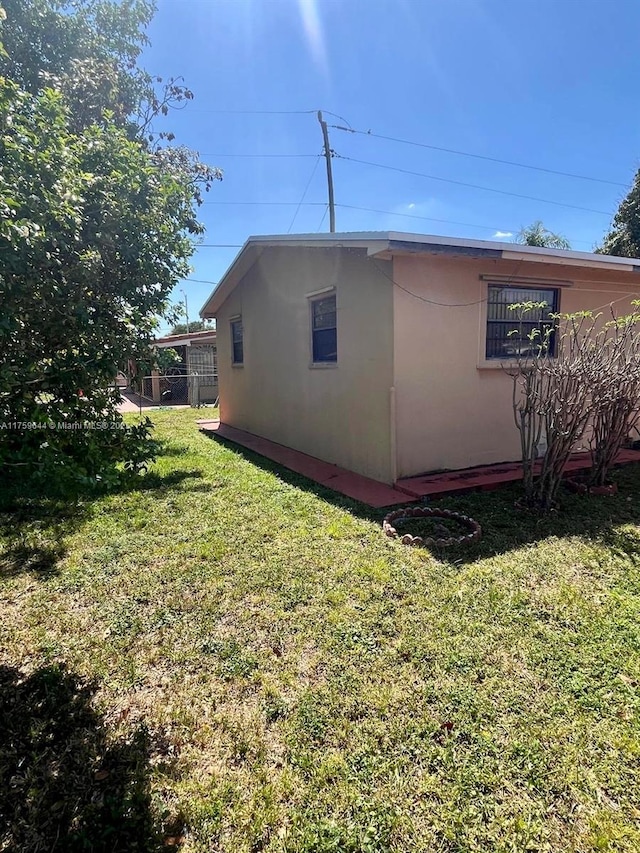 view of property exterior with a yard and stucco siding